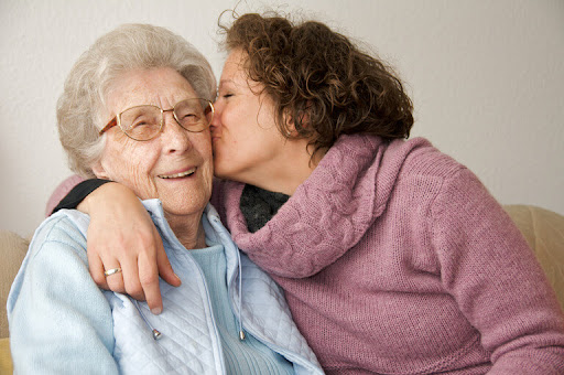 senior kissed by family member